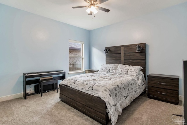 bedroom with a ceiling fan, light carpet, and baseboards