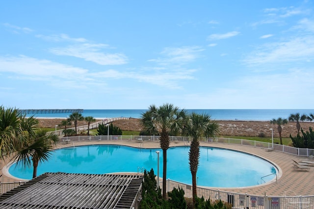 view of swimming pool with a water view