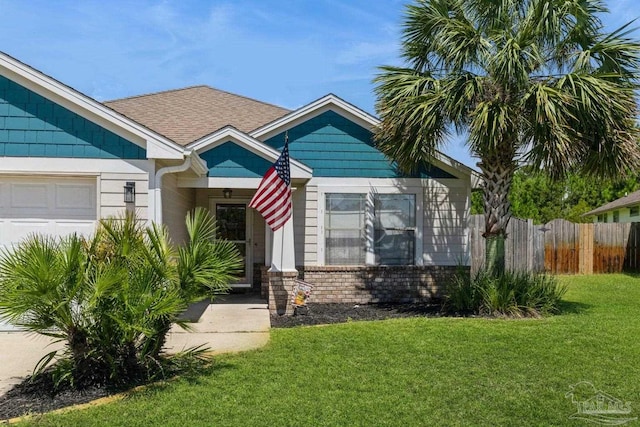 view of front facade with a garage and a front lawn