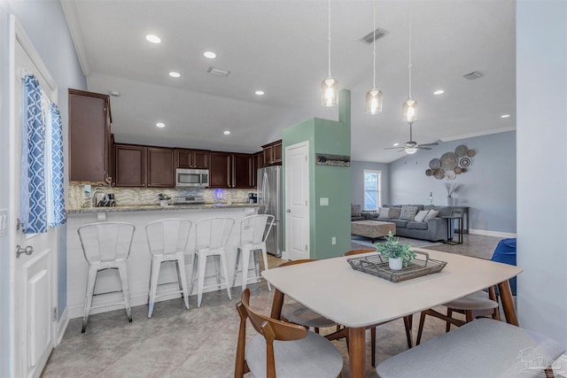 dining room with ceiling fan and ornamental molding