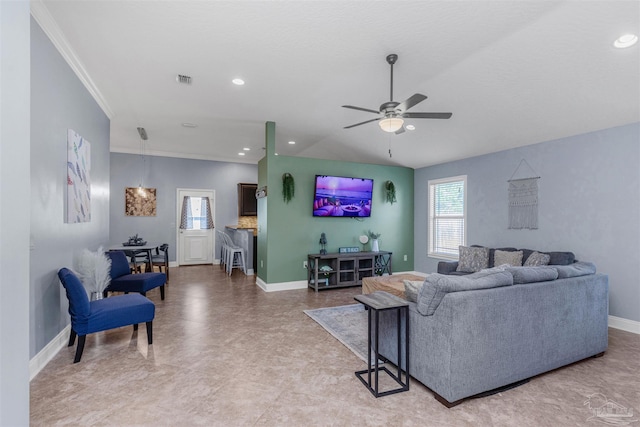 living room with ceiling fan and ornamental molding