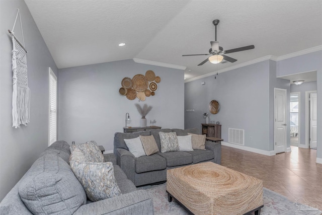 living room featuring vaulted ceiling, a wealth of natural light, ceiling fan, and light tile patterned floors