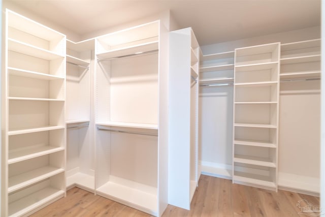 spacious closet featuring hardwood / wood-style floors