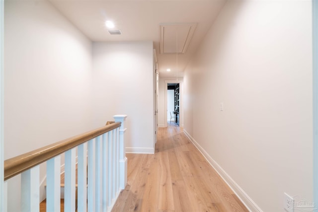 corridor with light hardwood / wood-style flooring