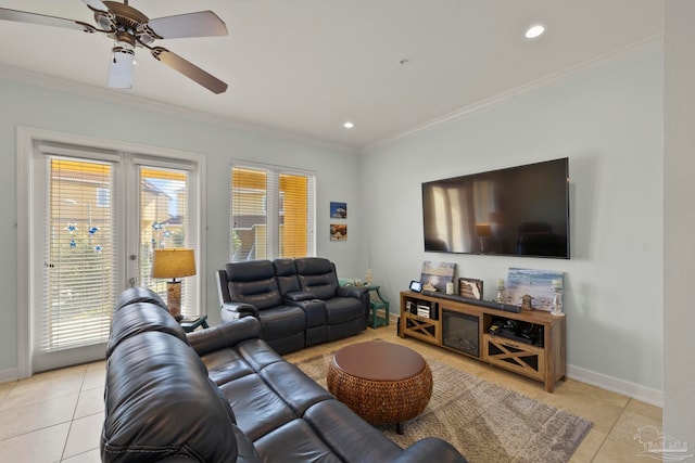 tiled living room with ceiling fan, a wealth of natural light, and ornamental molding