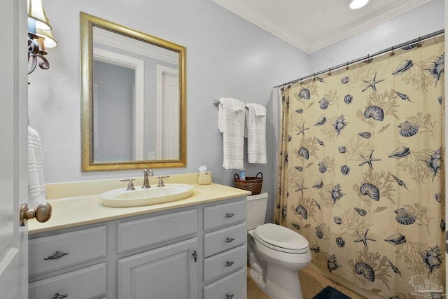 bathroom with vanity, crown molding, and toilet