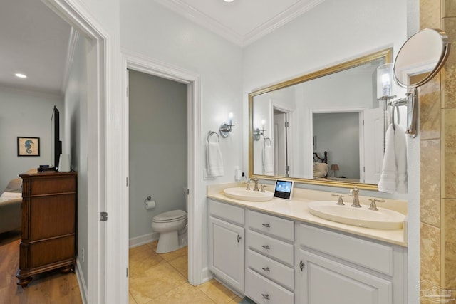 bathroom featuring double vanity, tile patterned floors, toilet, and ornamental molding