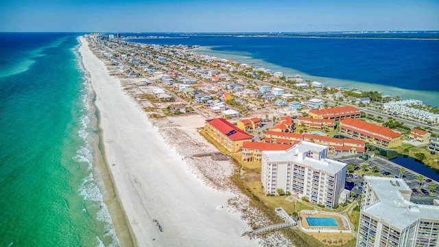 drone / aerial view with a water view and a beach view