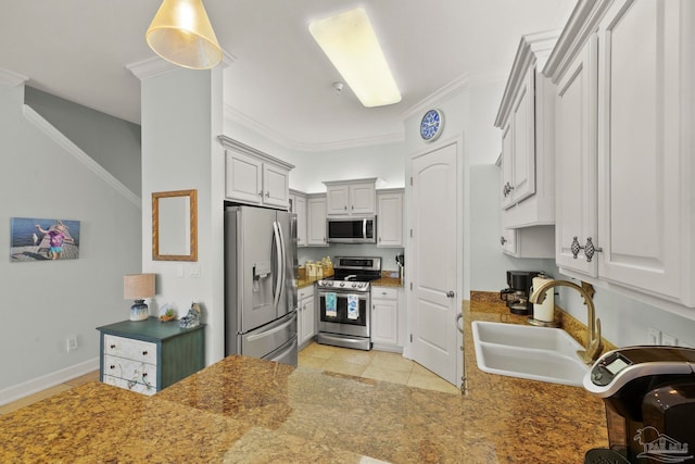 kitchen with sink, appliances with stainless steel finishes, ornamental molding, and light tile patterned floors