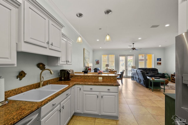 kitchen with light tile patterned flooring, white cabinets, ceiling fan, appliances with stainless steel finishes, and sink