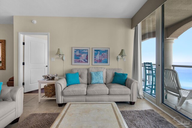 living room featuring a wealth of natural light and light tile patterned floors