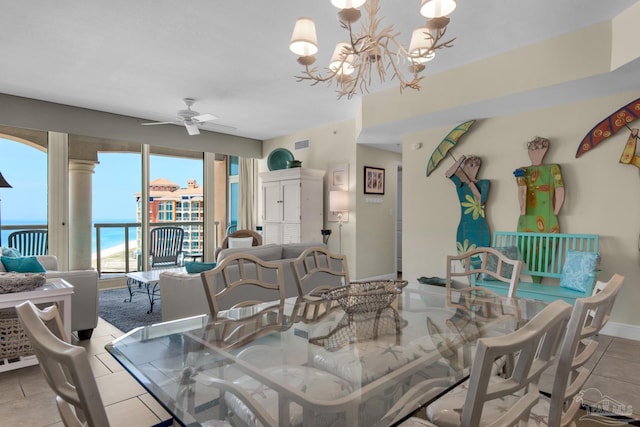 dining space with ceiling fan with notable chandelier, baseboards, visible vents, and tile patterned floors