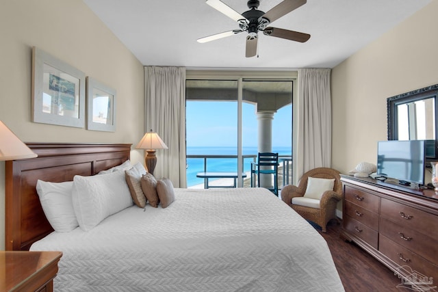 bedroom with access to outside, expansive windows, dark wood finished floors, and a ceiling fan