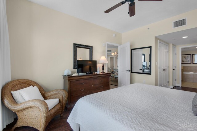 bedroom with ceiling fan, dark hardwood / wood-style flooring, and connected bathroom