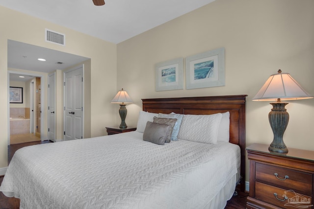 bedroom featuring ceiling fan, ensuite bathroom, and hardwood / wood-style floors