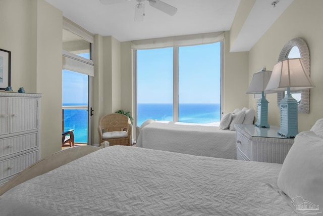 bedroom with access to outside, multiple windows, a water view, and a ceiling fan