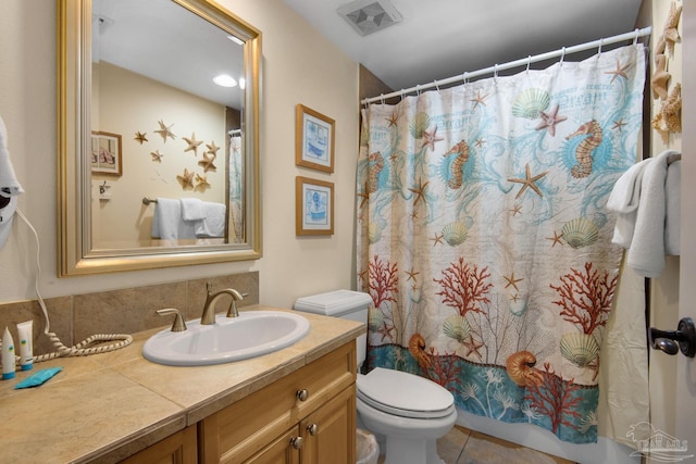 bathroom with tile patterned flooring, toilet, and vanity