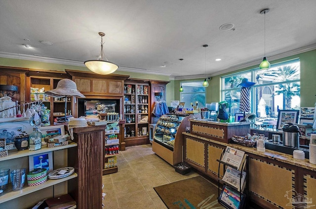 kitchen with light tile patterned floors, ornamental molding, and pendant lighting