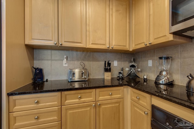 kitchen with wall oven, tasteful backsplash, dark stone counters, stainless steel microwave, and black electric cooktop