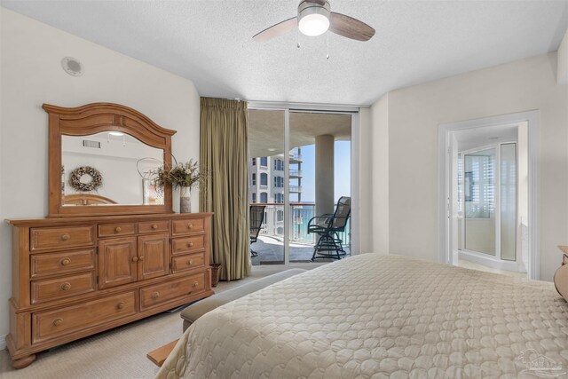 carpeted bedroom featuring ceiling fan, a textured ceiling, access to exterior, and a wall of windows