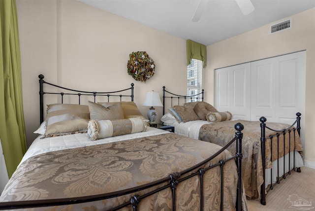 carpeted bedroom with a closet and ceiling fan