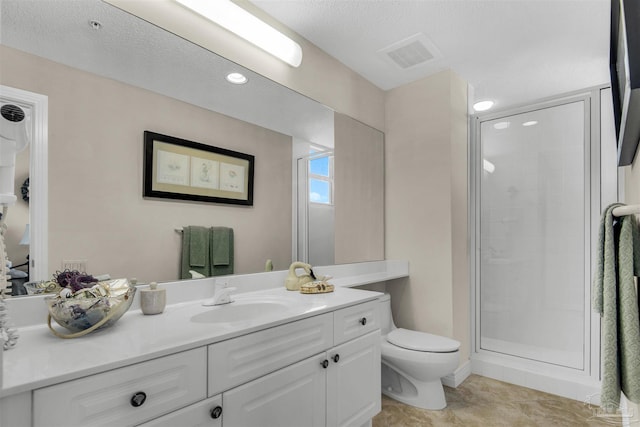 bathroom with vanity, tile patterned flooring, a shower with door, and toilet