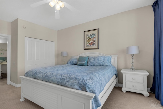 carpeted bedroom featuring ceiling fan and a closet