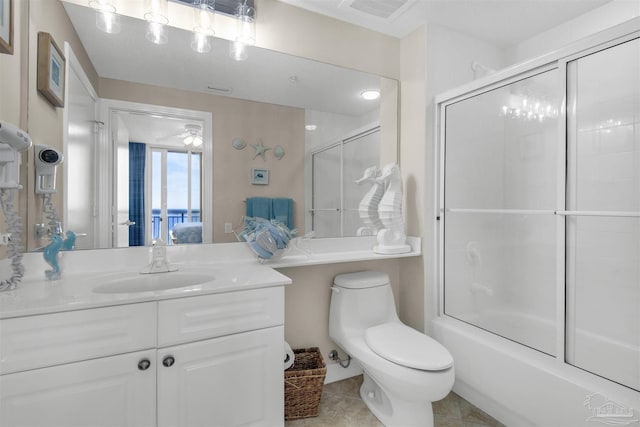 full bathroom with enclosed tub / shower combo, vanity, tile patterned floors, and toilet