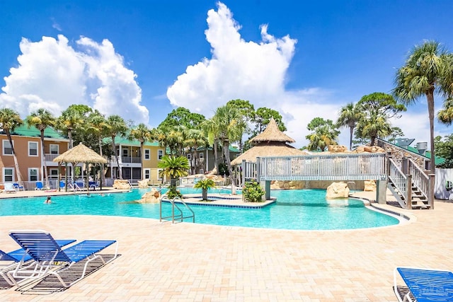 community pool featuring a patio area and fence