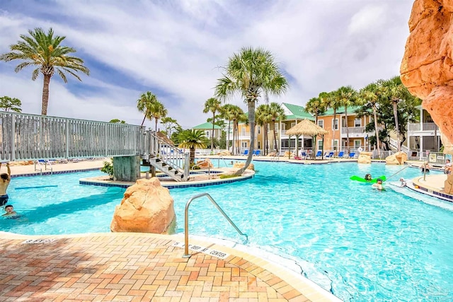 community pool featuring a patio and fence