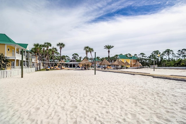 view of community featuring volleyball court and fence