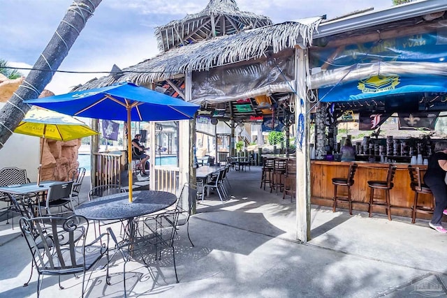 view of patio with outdoor dry bar and outdoor dining area