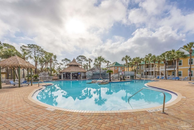 community pool with a patio area and a gazebo