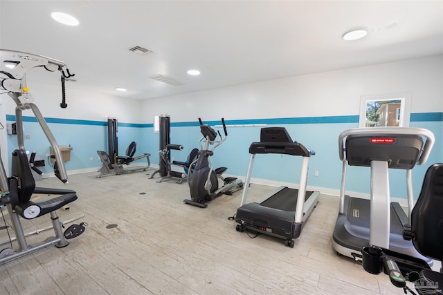 workout area with recessed lighting, visible vents, baseboards, and wood finished floors