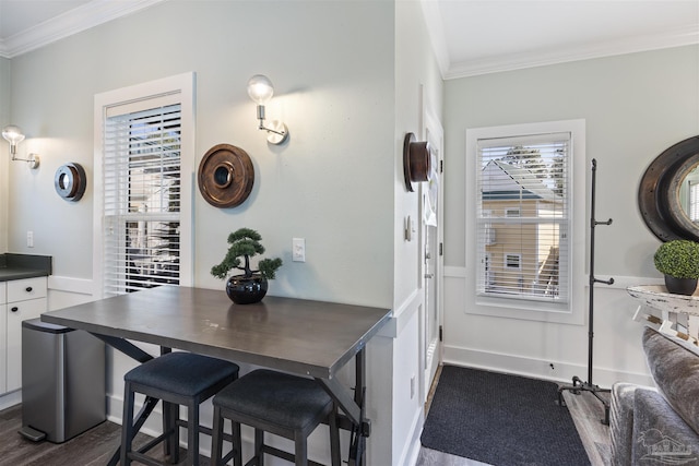 interior space with dark wood-style flooring, white cabinetry, baseboards, ornamental molding, and dark countertops