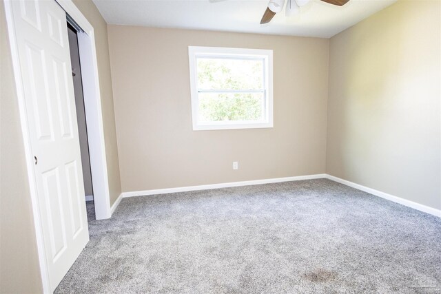 unfurnished room featuring light carpet and ceiling fan