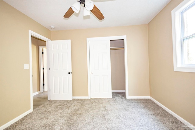 unfurnished bedroom with light carpet, ceiling fan, and a closet