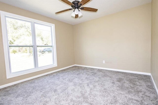 unfurnished room with a healthy amount of sunlight, carpet, and ceiling fan