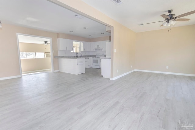 unfurnished living room with light hardwood / wood-style flooring, sink, and ceiling fan