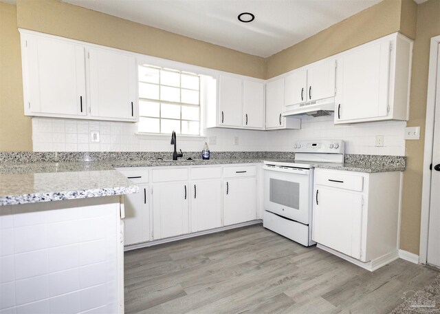 kitchen with white cabinetry, light hardwood / wood-style flooring, white electric range, light stone countertops, and sink