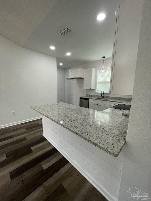 kitchen featuring white cabinets, a peninsula, dishwasher, light stone countertops, and hanging light fixtures