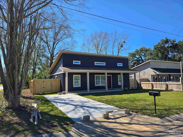 view of front of home with a gate, fence, a front lawn, and covered porch