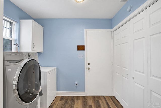 laundry room with cabinet space, baseboards, dark wood-style flooring, and washing machine and clothes dryer