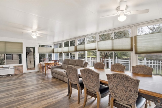 sunroom / solarium featuring a ceiling fan