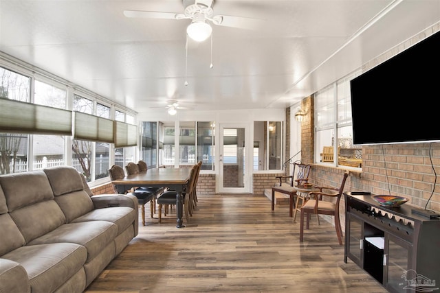 sunroom featuring ceiling fan