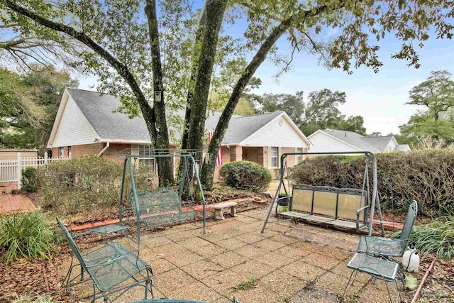 view of patio / terrace featuring fence