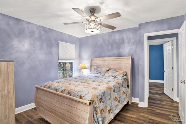 bedroom featuring wood finished floors, a ceiling fan, and baseboards