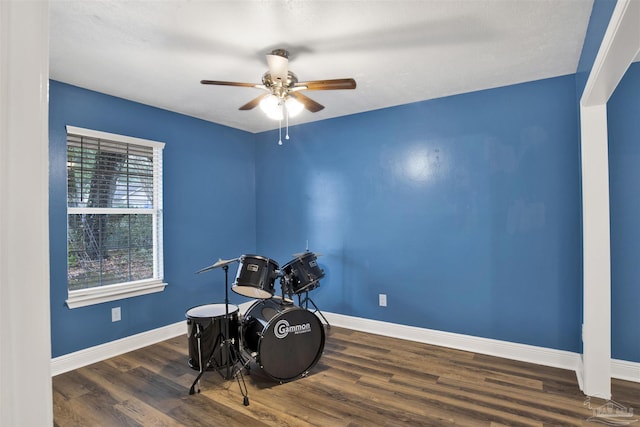 miscellaneous room with ceiling fan, wood finished floors, and baseboards