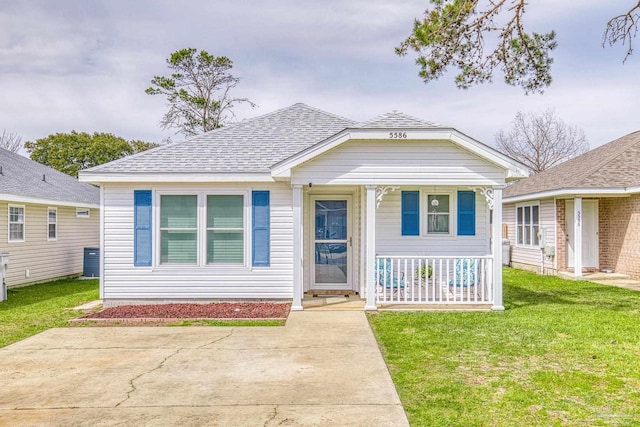 bungalow-style home featuring covered porch, roof with shingles, and a front lawn