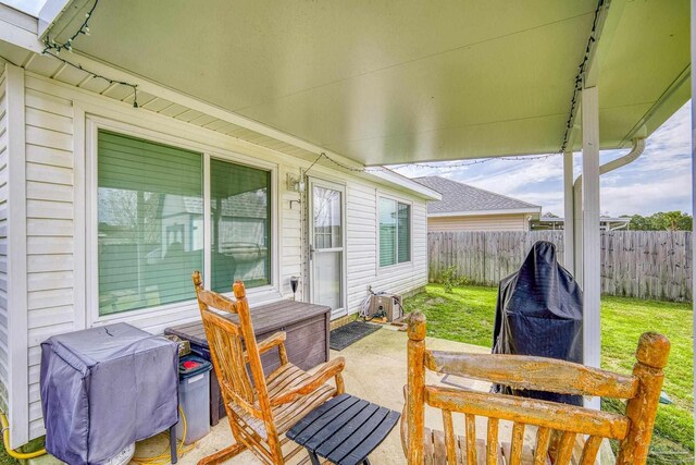 deck with a lawn, a patio area, and a fenced backyard